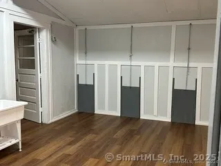 an empty room with wooden floor and closet