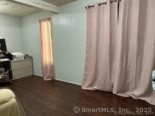 a view of a room with window and hardwood