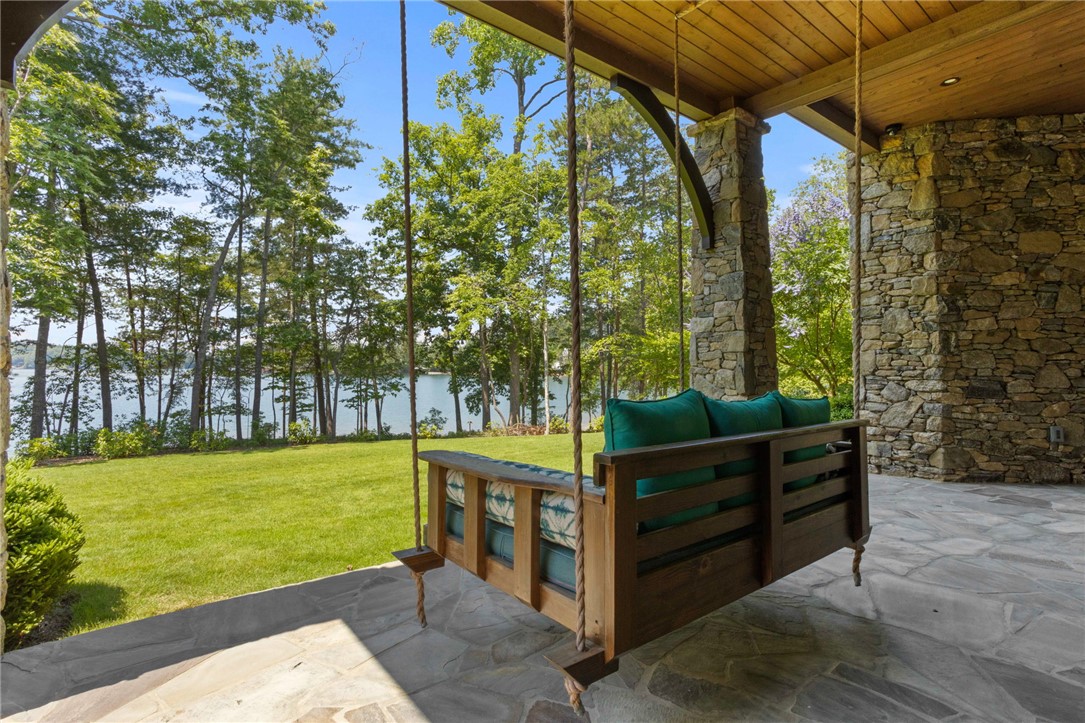 236 Palmer Way Sunset, SC 29685 - Photo 30 of 46 A tranquil lakeside retreat with a welcoming porch swing and natural stone accents.