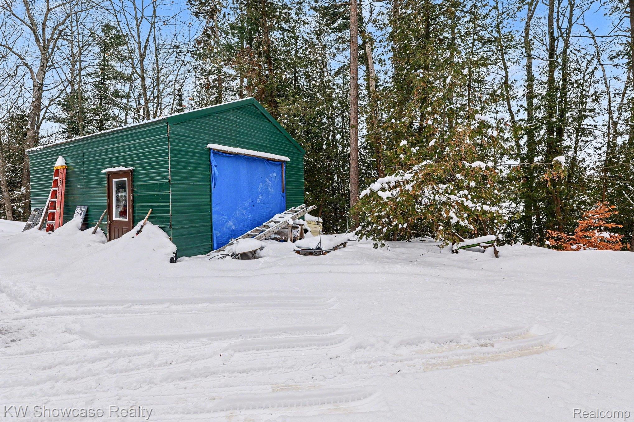 1951 East Kneeland Road Fairview, MI 48621 - Photo 33 of 46 View of snow covered garage