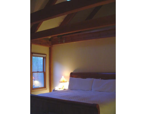 123 Randall Road Berlin, MA 01503 - Photo 15 of 26 a bedroom with a bed and a potted plant