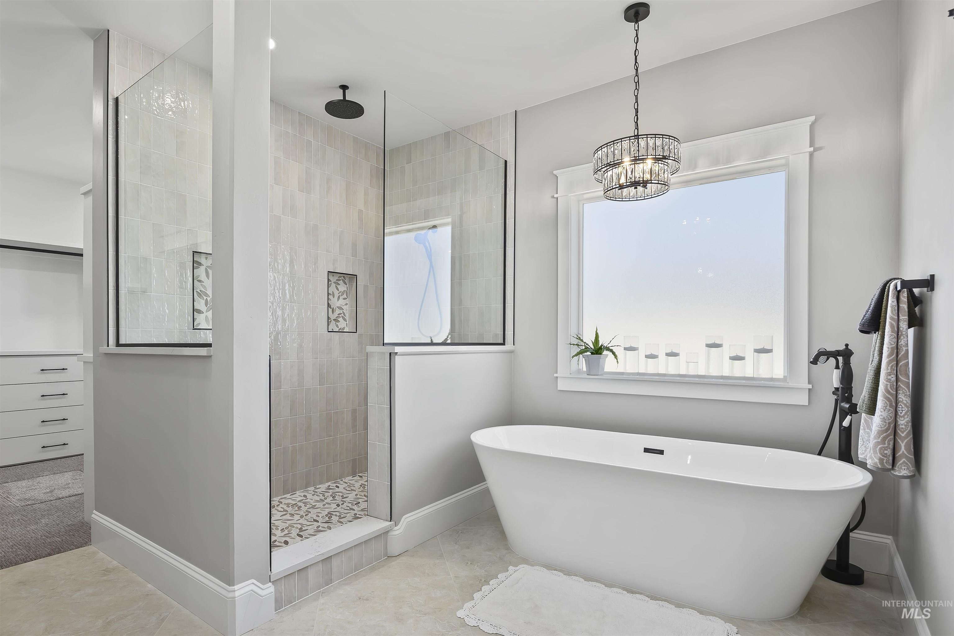 378 West 100 South Rupert, ID 83350 - Photo 26 of 50 Freestanding soaking tub with a floor-mounted faucet, complemented by a large window with detailed trim