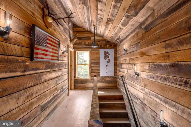 a view of a room with lots of wooden furniture and a window