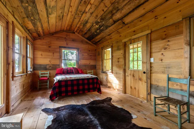 a living room with a bed furniture and a window