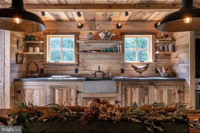 a kitchen with a stove a sink and cabinets
