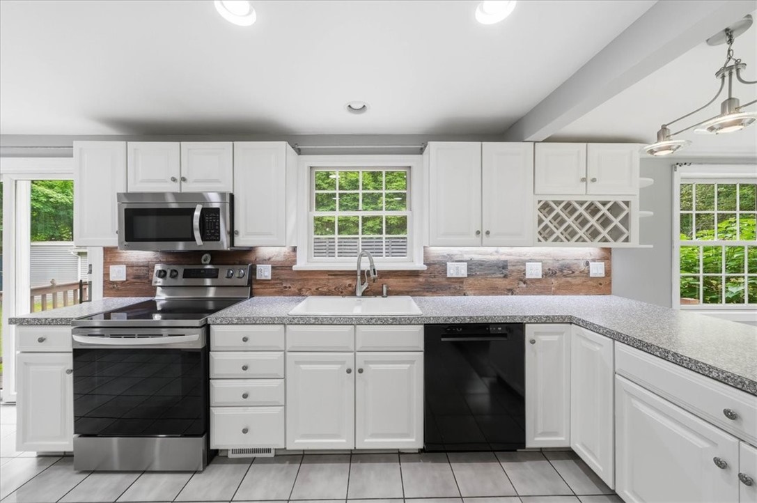 214 Anan Wade Road Glocester, RI 02857 - Photo 14 of 50 The roomy kitchen offers abundant cabinetry and counter space, stainless steel appliances, recessed lighting and a convenient breakfast bar overlooking the living room.