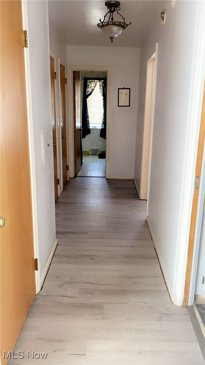 15657 Fenemore Road Cleveland, OH 44112 - Photo 8 of 26 Hallway with light hardwood / wood-style floors