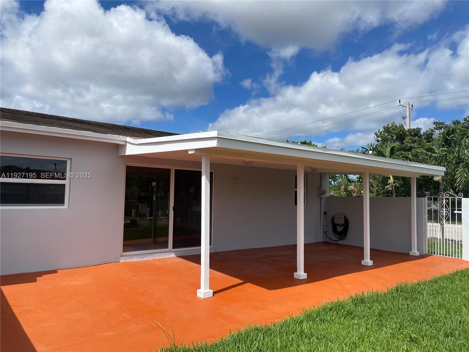 13017 Southwest 18th Terrace, Unit 13017 Miami, FL 33175 - Photo 14 of 21 a view of a backyard with brick wall and a large window