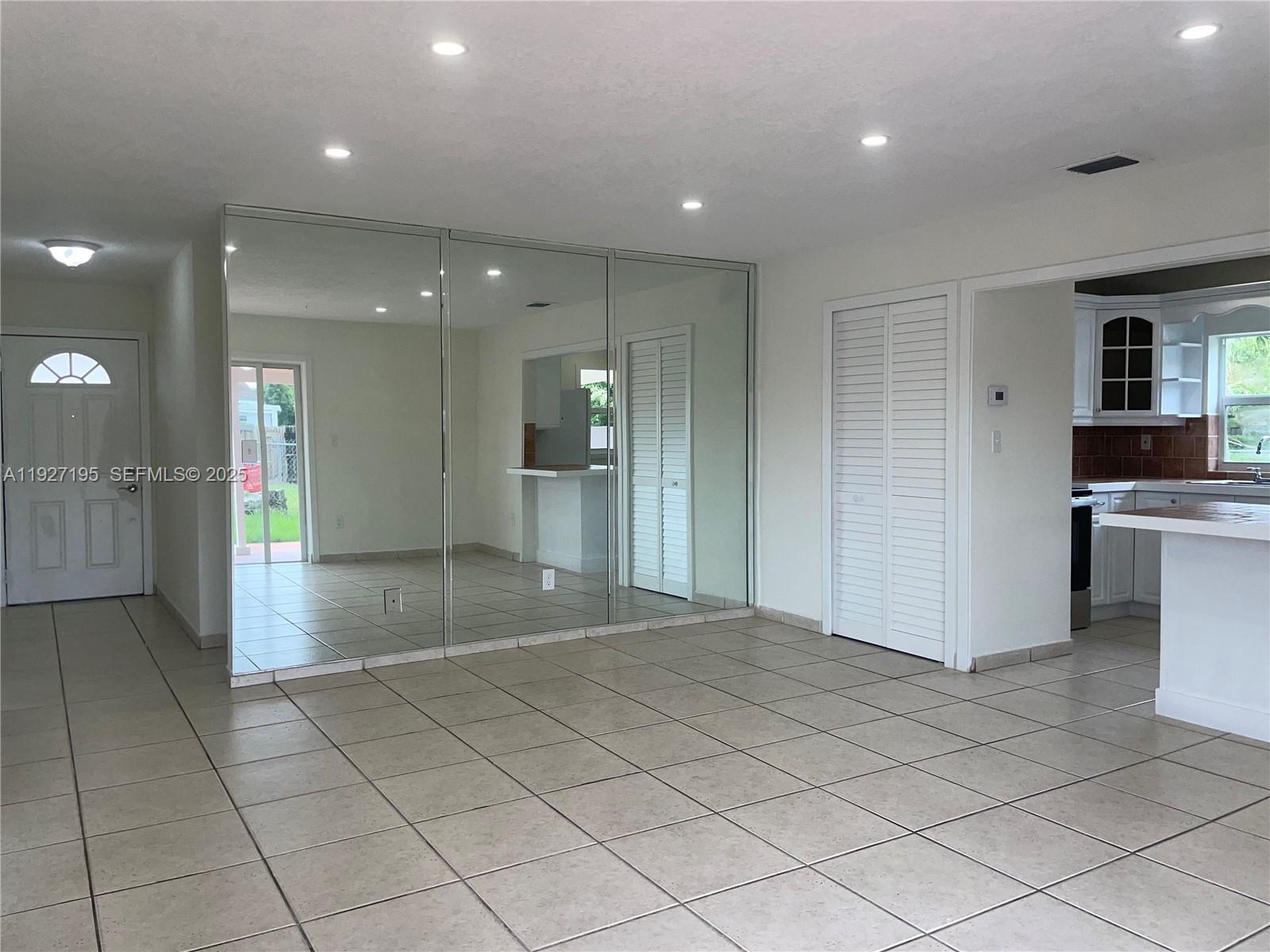 13017 Southwest 18th Terrace, Unit 13017 Miami, FL 33175 - Photo 18 of 21 a view of a hallway with wooden shelves