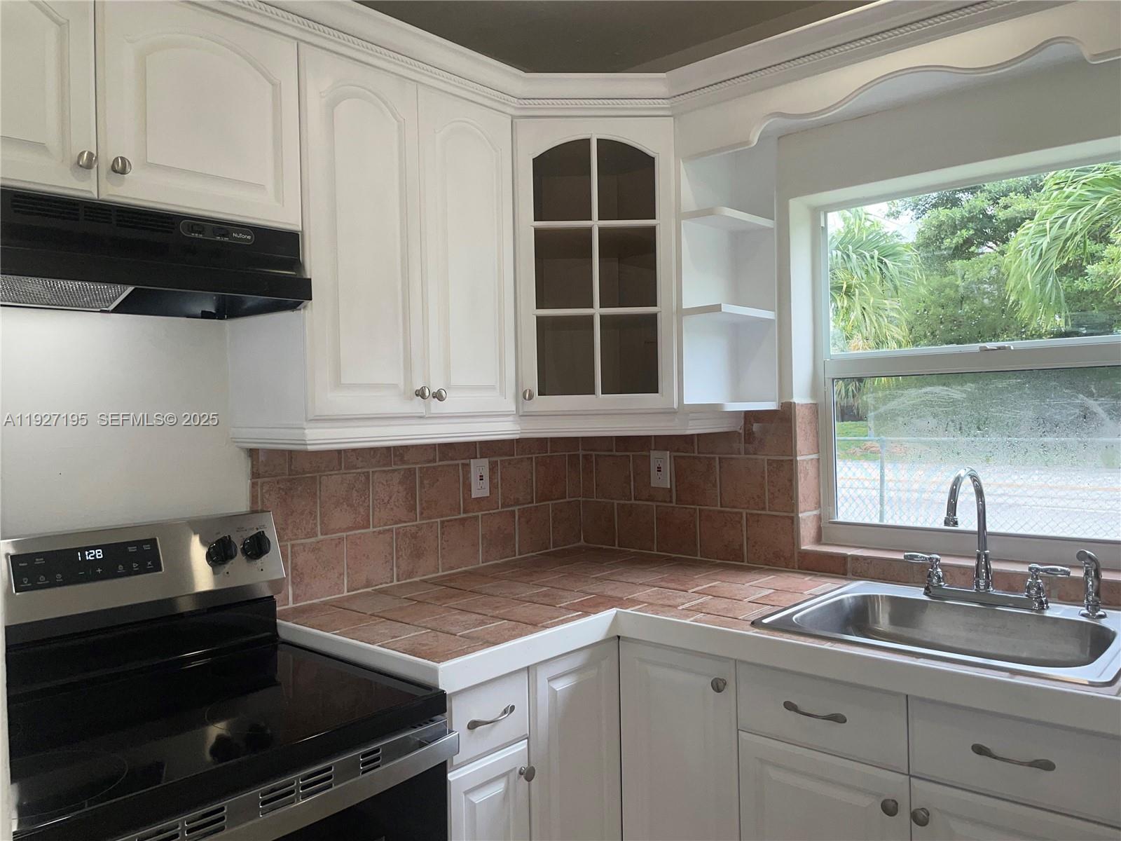 13017 Southwest 18th Terrace, Unit 13017 Miami, FL 33175 - Photo 2 of 21 a kitchen with a sink and cabinets