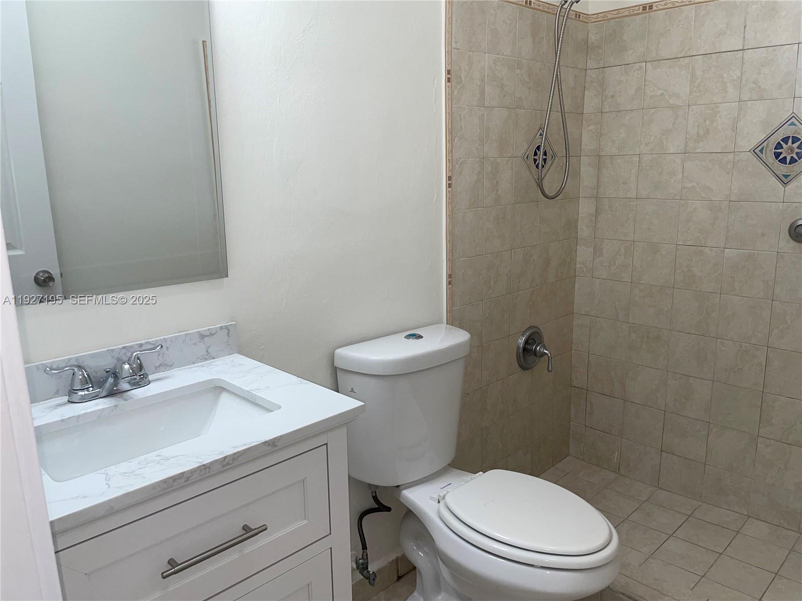 13017 Southwest 18th Terrace, Unit 13017 Miami, FL 33175 - Photo 8 of 21 a white toilet sitting next to a bathroom sink