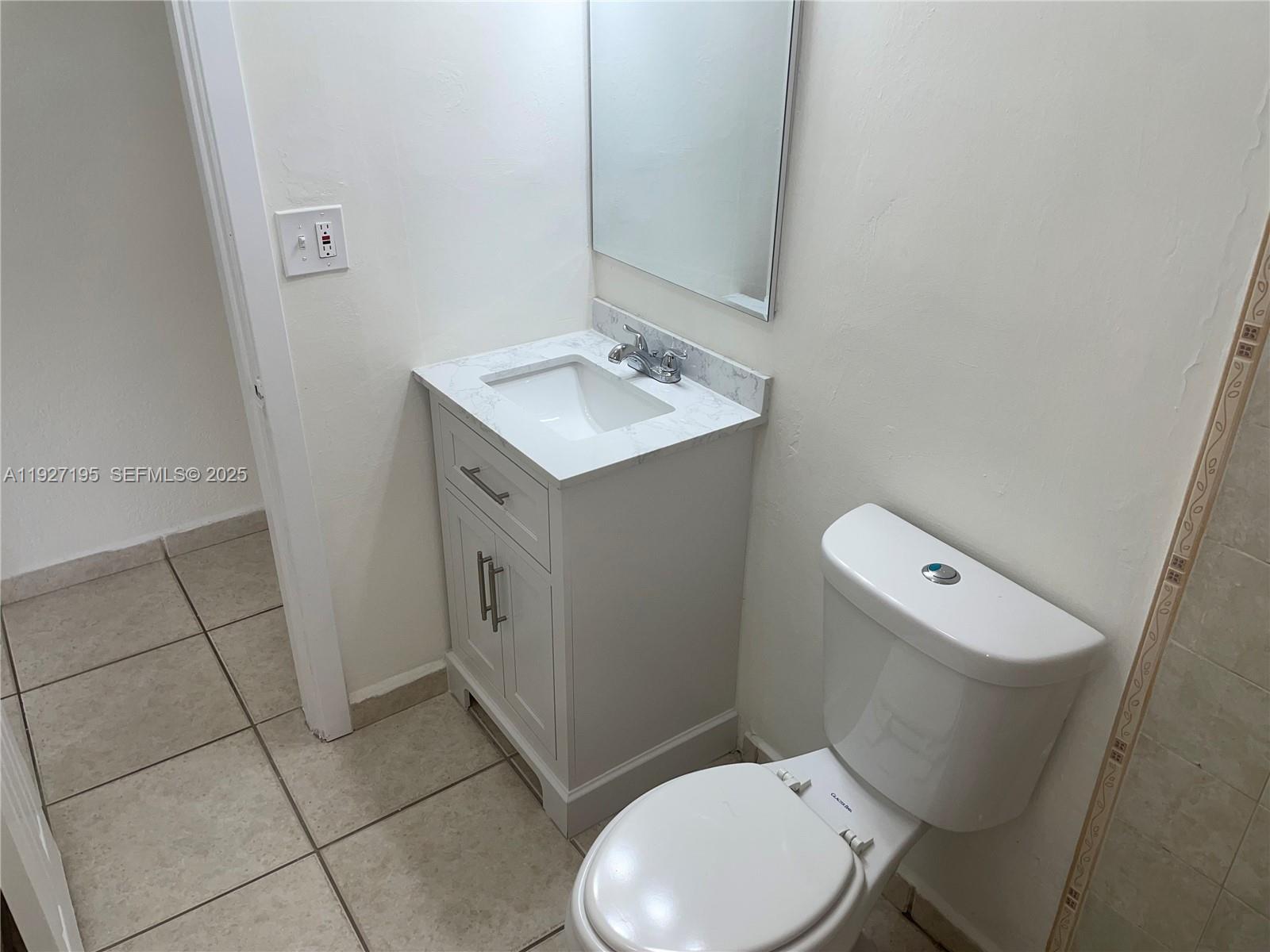 13017 Southwest 18th Terrace, Unit 13017 Miami, FL 33175 - Photo 9 of 21 a white toilet sitting next to a bathroom sink