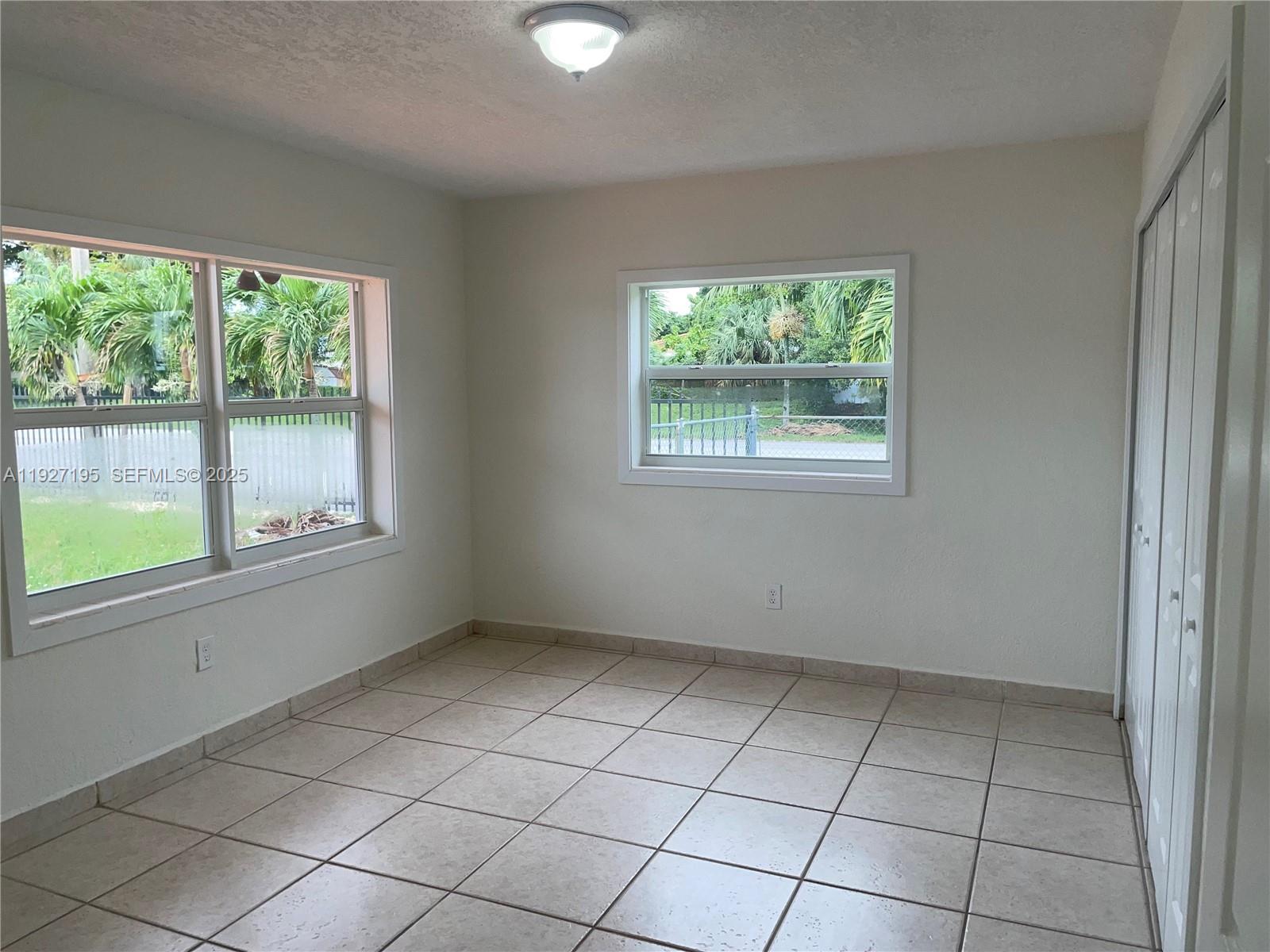 13017 Southwest 18th Terrace, Unit 13017 Miami, FL 33175 - Photo 10 of 21 an empty room with windows
