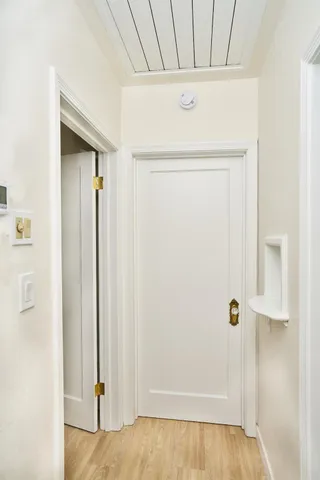 a view of a room with wooden floor
