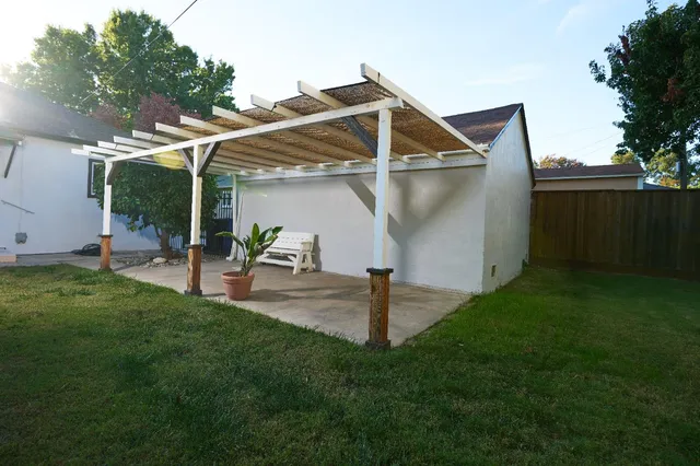 a view of a small house with a yard