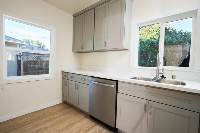 a kitchen with a sink cabinets and window