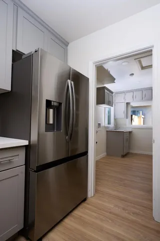 a kitchen with stainless steel appliances granite countertop a refrigerator and a sink