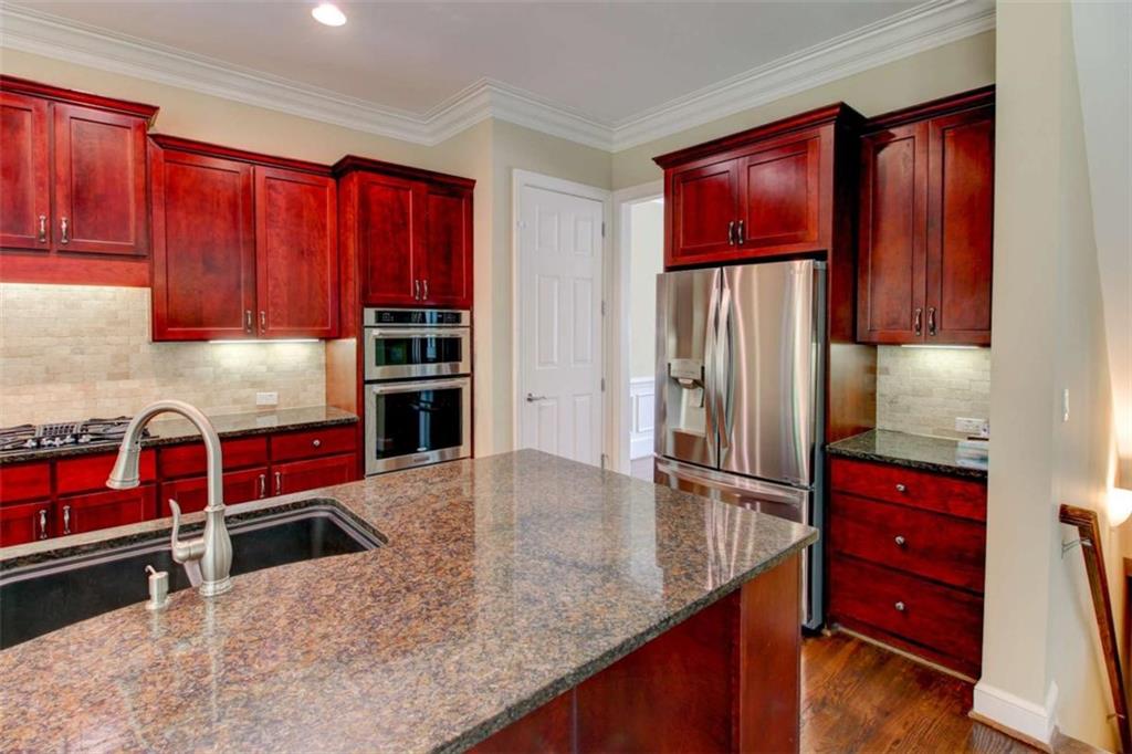 7520 Ledgewood Way Suwanee, GA 30024 - Photo 17 of 95 a kitchen with stainless steel appliances granite countertop a refrigerator and a stove