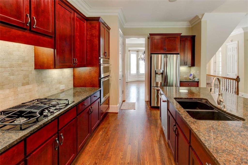 7520 Ledgewood Way Suwanee, GA 30024 - Photo 19 of 95 a kitchen with granite countertop a stove and cabinets