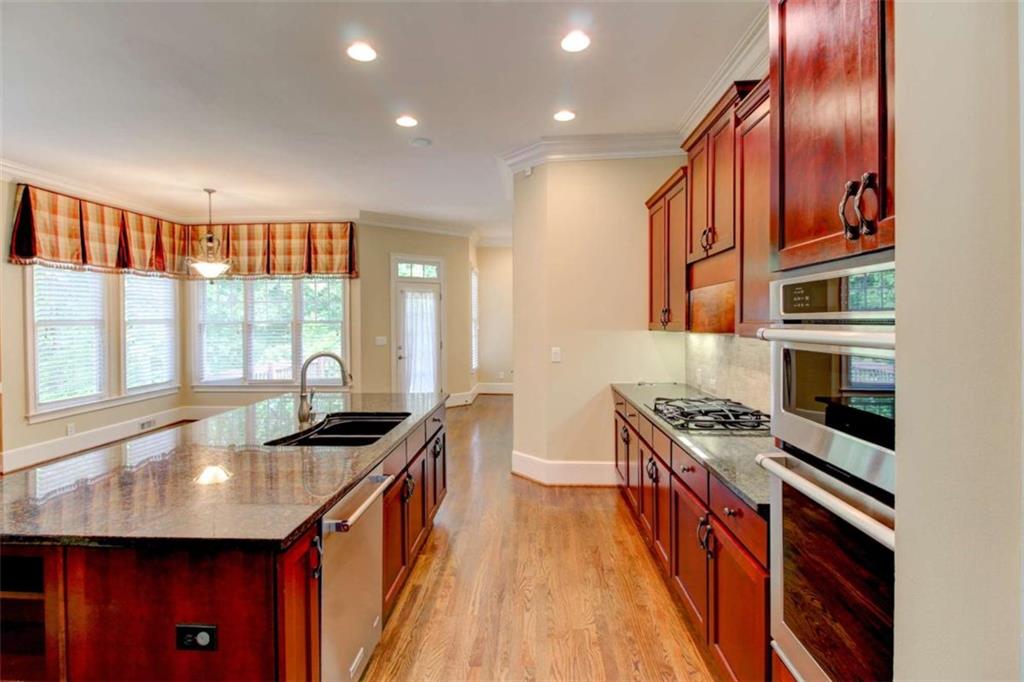 7520 Ledgewood Way Suwanee, GA 30024 - Photo 21 of 95 a kitchen with stainless steel appliances granite countertop a stove a sink and a refrigerator
