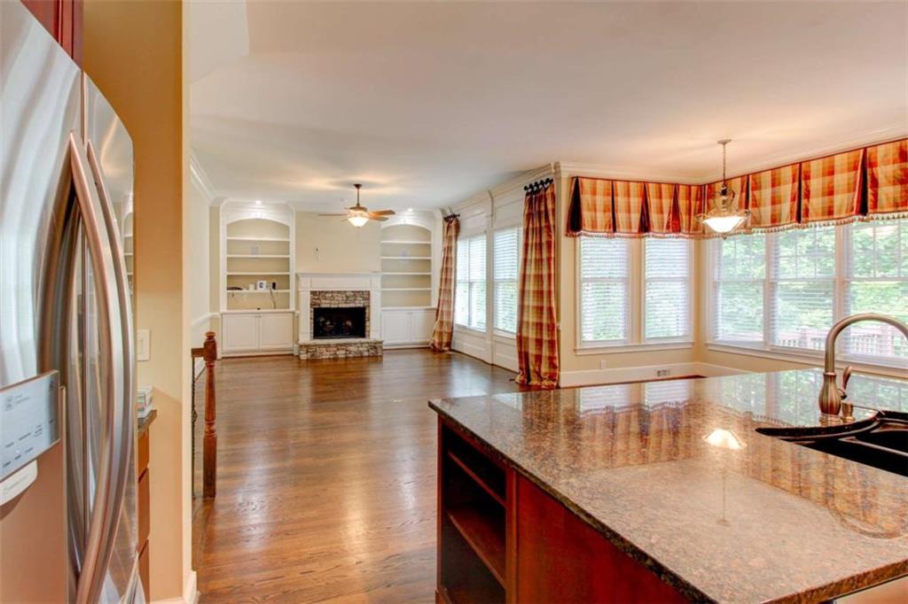 7520 Ledgewood Way Suwanee, GA 30024 - Photo 22 of 95 a kitchen with stainless steel appliances granite countertop a sink a stove and a refrigerator