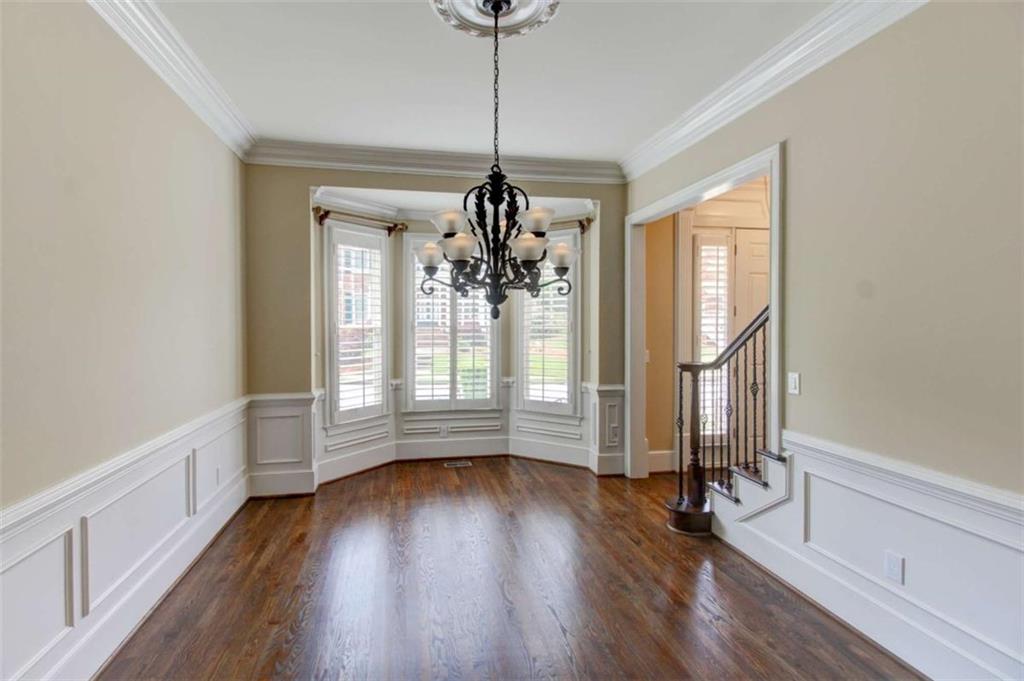 7520 Ledgewood Way Suwanee, GA 30024 - Photo 24 of 95 a view of empty room with wooden floor and fan