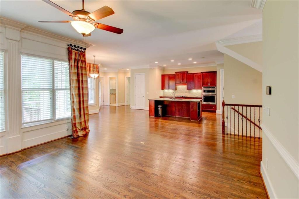7520 Ledgewood Way Suwanee, GA 30024 - Photo 27 of 95 a view of a livingroom with furniture wooden floor a ceiling fan and windows