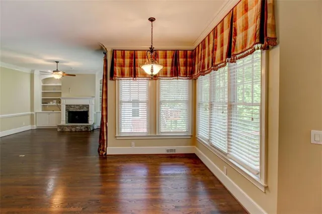 a view of a livingroom with a ceiling fan and window
