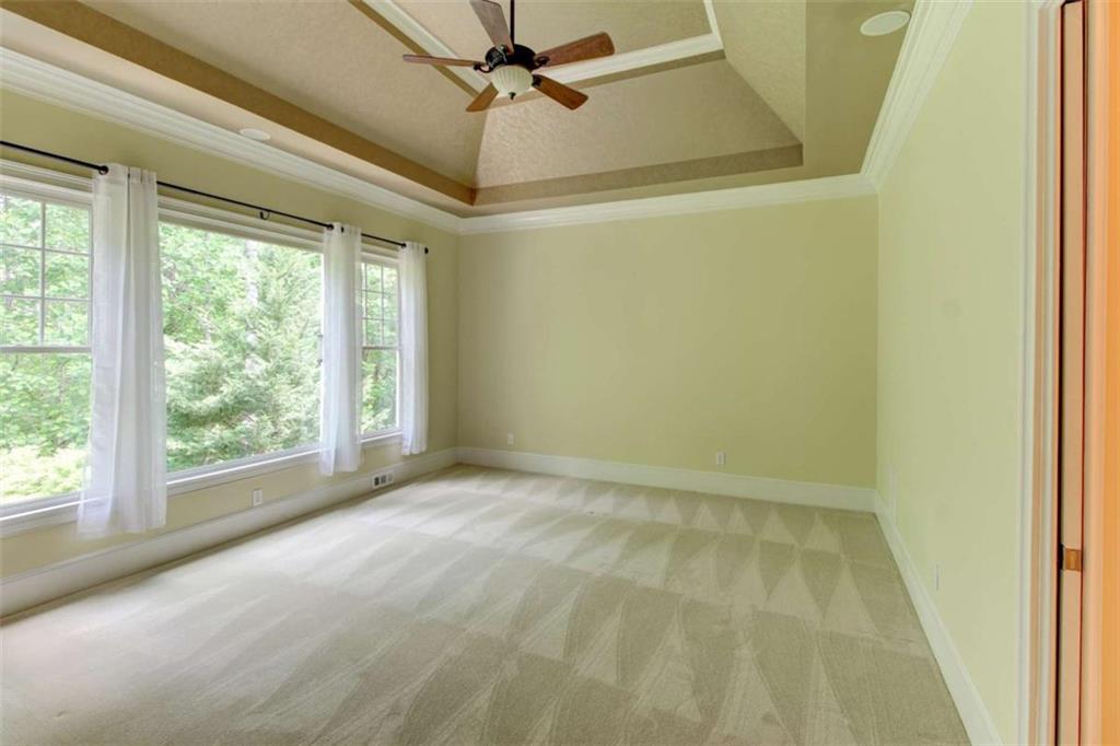 7520 Ledgewood Way Suwanee, GA 30024 - Photo 31 of 95 a view of room with window and a ceiling fan