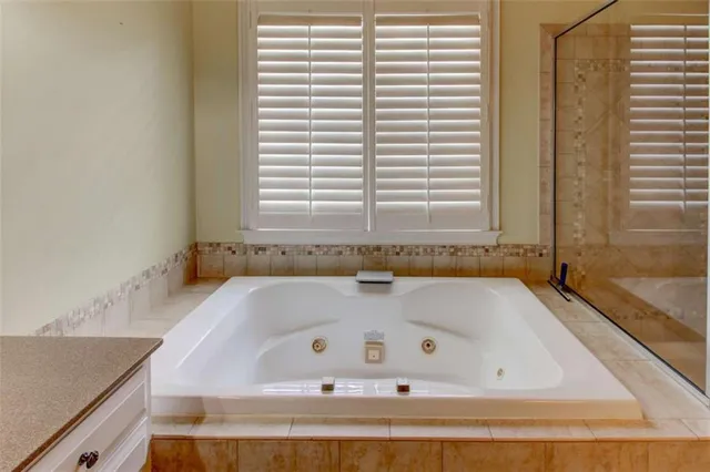 a view of an empty room with a fireplace and a window