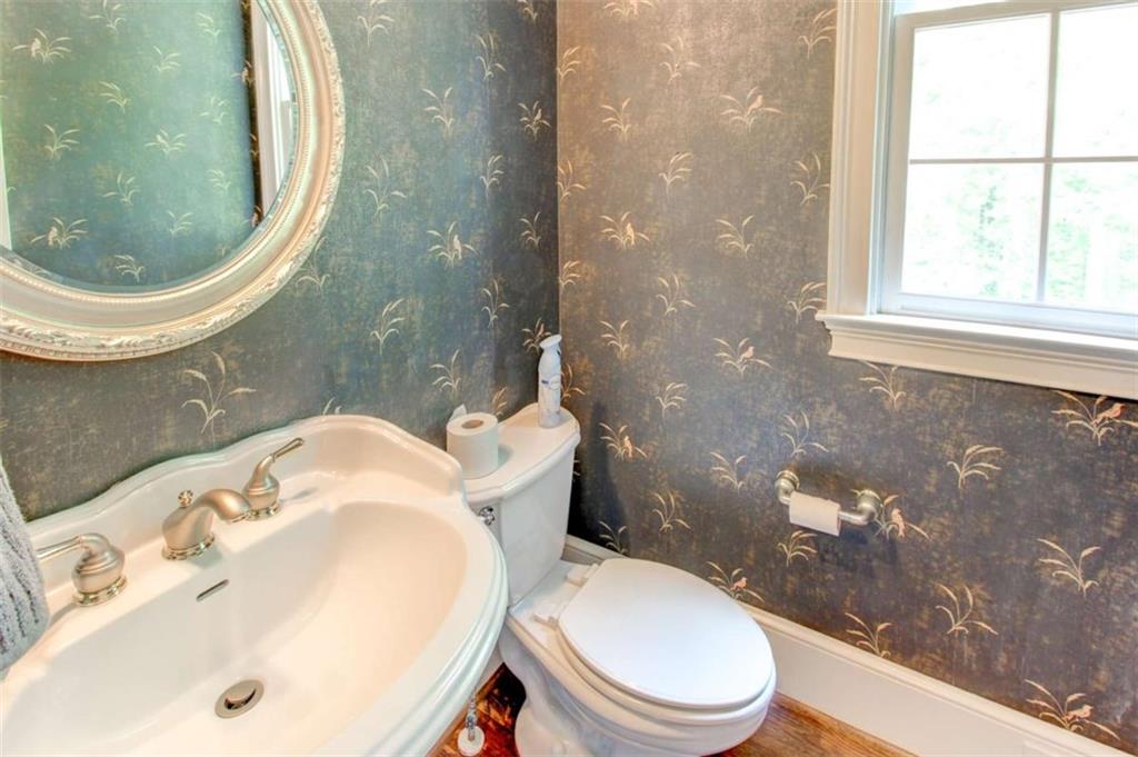 7520 Ledgewood Way Suwanee, GA 30024 - Photo 41 of 95 a white toilet sitting next to a bathroom sink