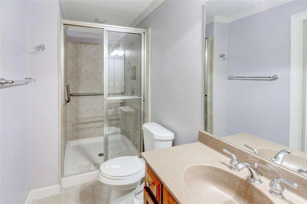 7520 Ledgewood Way Suwanee, GA 30024 - Photo 72 of 95 a bathroom with a granite countertop sink toilet and shower