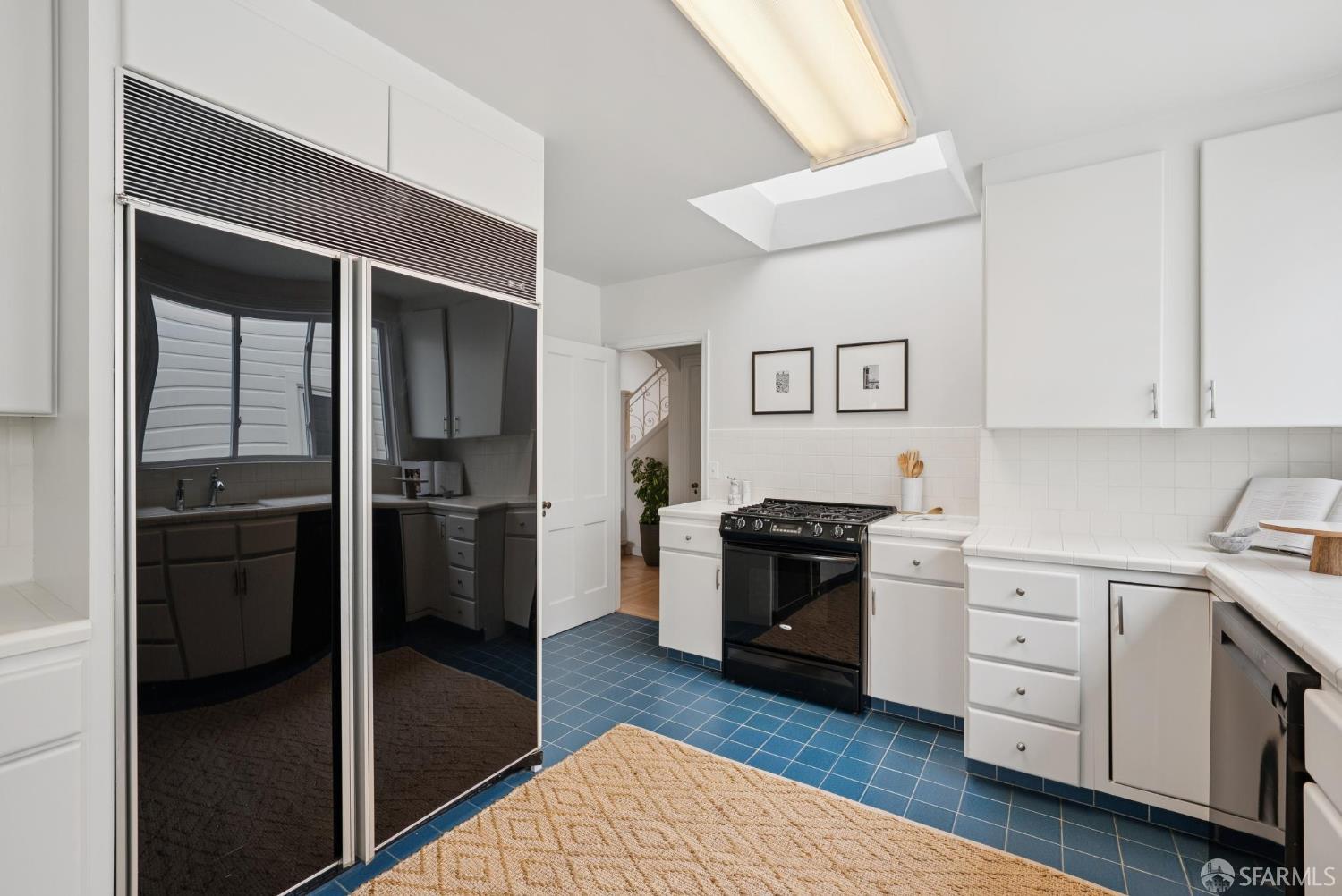1867 15th Avenue San Francisco, CA 94122 - Photo 19 of 75 a kitchen with a refrigerator and a stove top oven