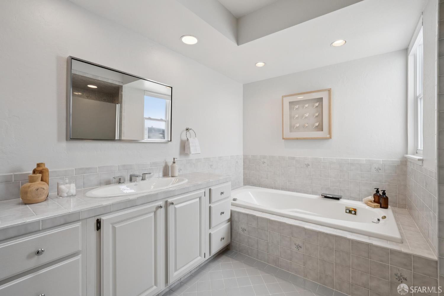 1867 15th Avenue San Francisco, CA 94122 - Photo 28 of 75 a bathroom with a tub a sink and mirror