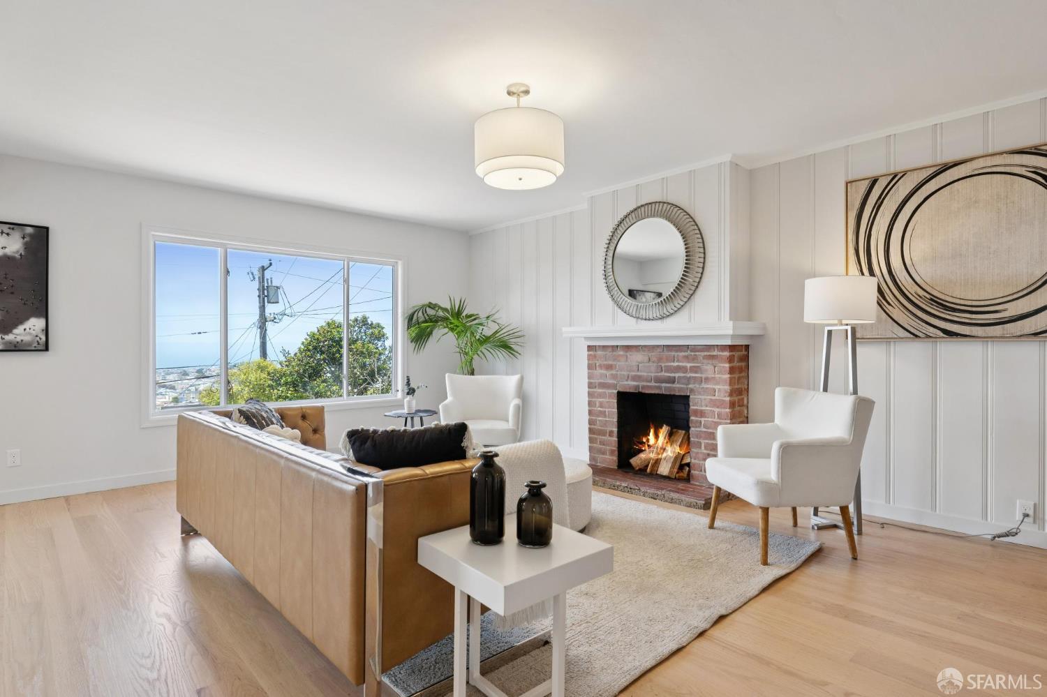 1867 15th Avenue San Francisco, CA 94122 - Photo 39 of 75 a living room with furniture a fireplace and a large window