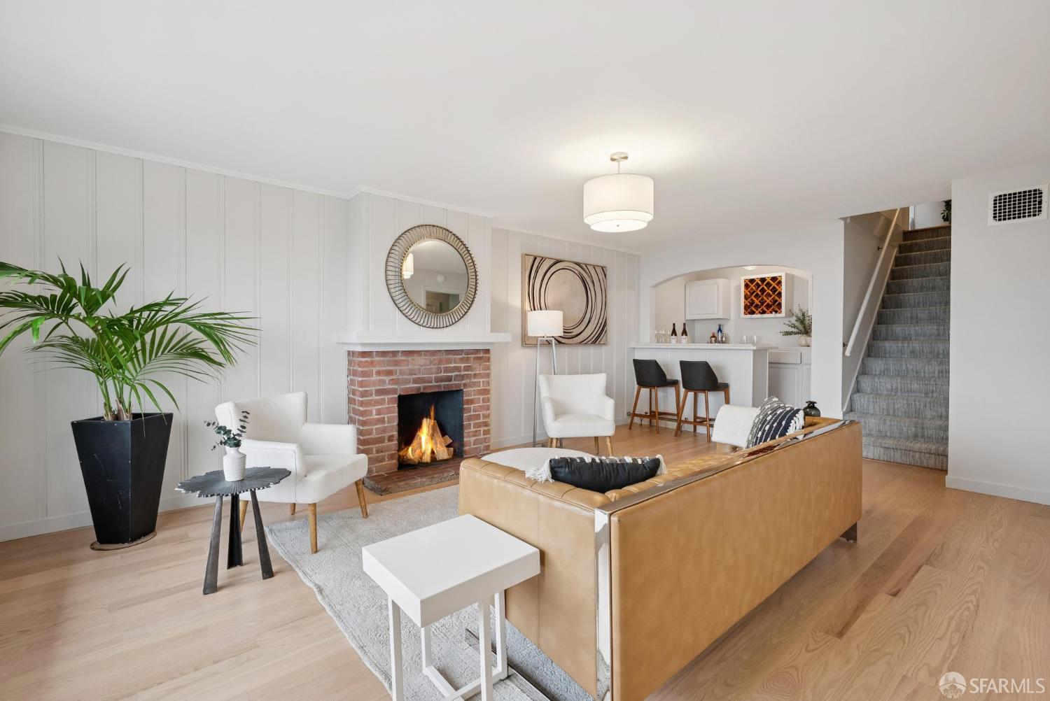 1867 15th Avenue San Francisco, CA 94122 - Photo 41 of 75 a living room with furniture a fireplace and a potted plant