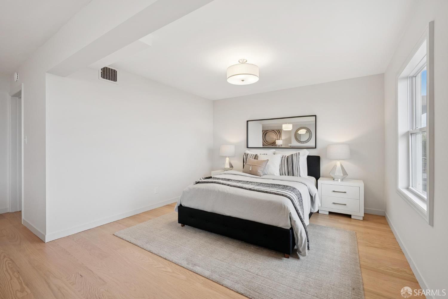 1867 15th Avenue San Francisco, CA 94122 - Photo 45 of 75 a spacious bedroom with a bed and a large window