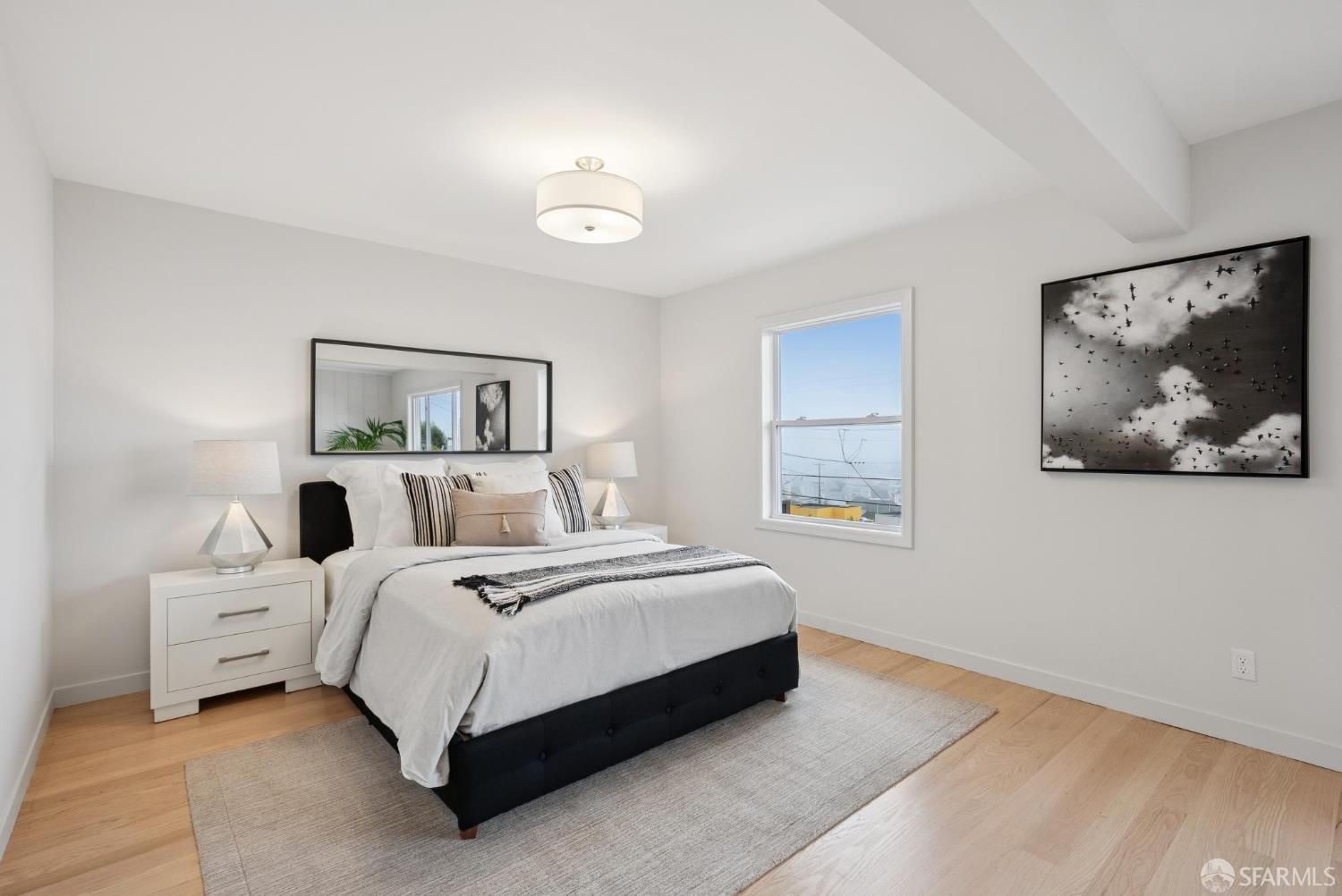 1867 15th Avenue San Francisco, CA 94122 - Photo 46 of 75 a bedroom with a bed and a painting on the wall