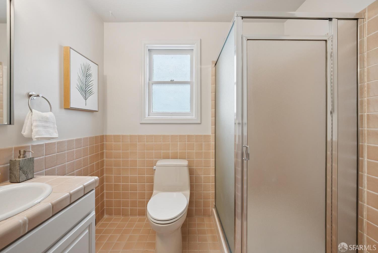 1867 15th Avenue San Francisco, CA 94122 - Photo 50 of 75 a bathroom with a sink a toilet and a mirror
