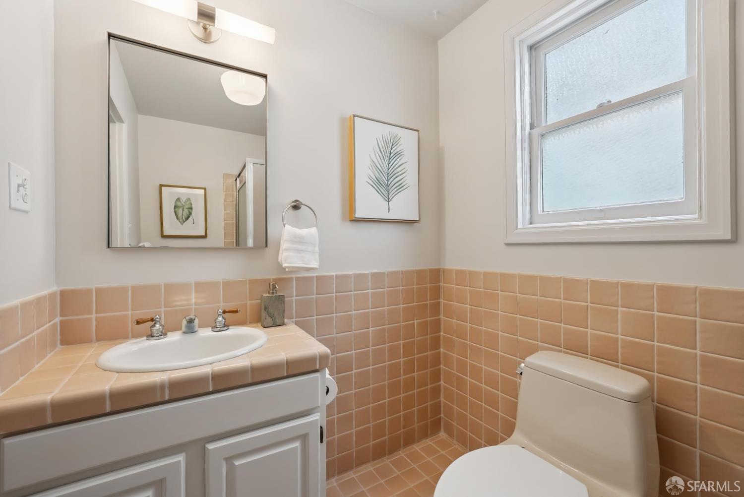 1867 15th Avenue San Francisco, CA 94122 - Photo 51 of 75 a bathroom with a sink a toilet and a mirror