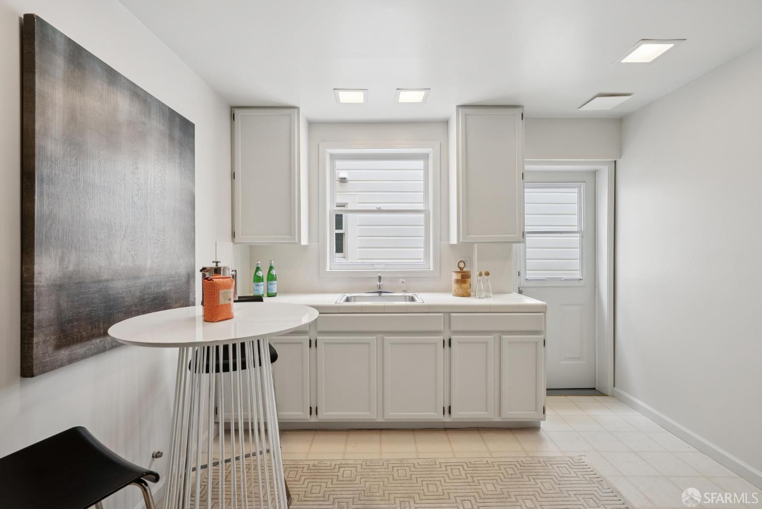 1867 15th Avenue San Francisco, CA 94122 - Photo 52 of 75 a kitchen with a sink stove and cabinets