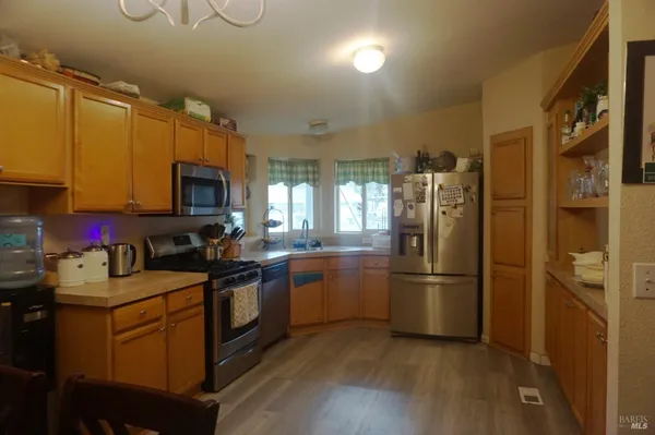 a kitchen with stainless steel appliances granite countertop a refrigerator stove and sink