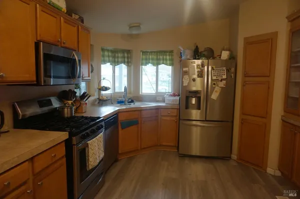 a kitchen with a sink appliances and cabinets