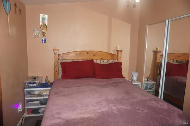 a bedroom with a bed and a closet