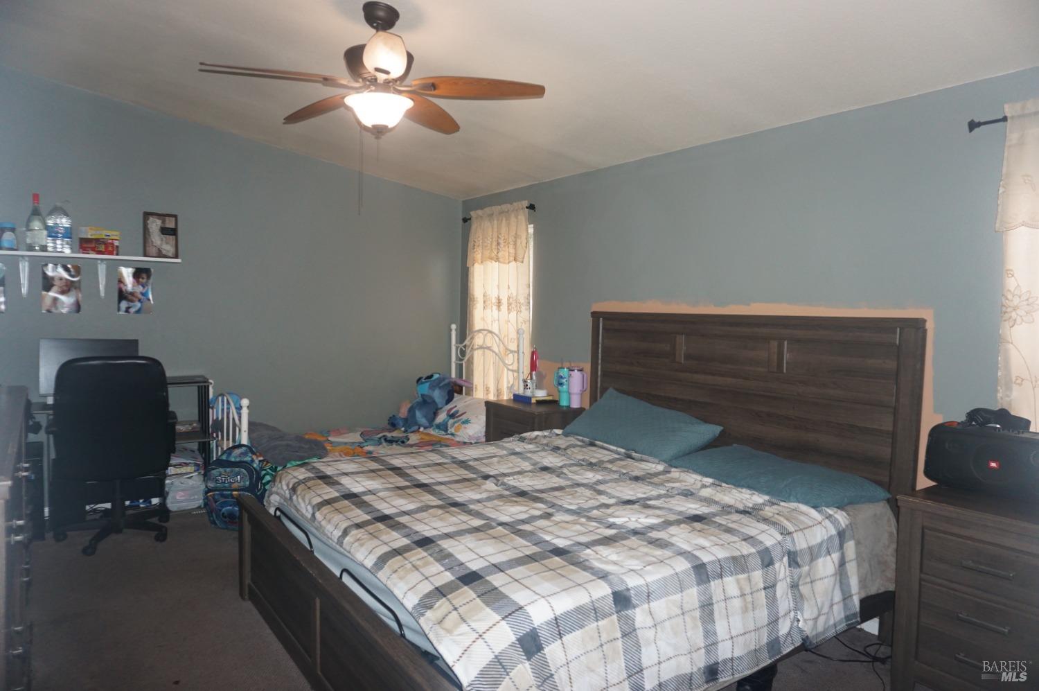6004 Monticello Road, Unit 7 Napa, CA 94558 - Photo 24 of 33 a bedroom with a bed and a chair with the potted plant