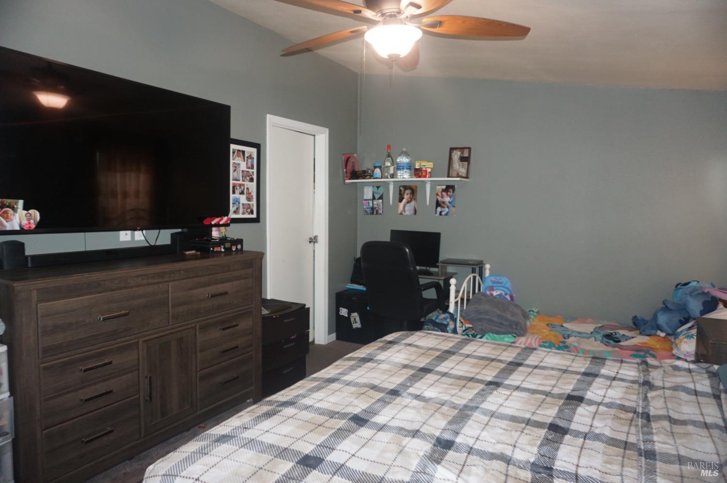 6004 Monticello Road, Unit 7 Napa, CA 94558 - Photo 25 of 33 a bedroom with a bed and a flat tv screen on dresser
