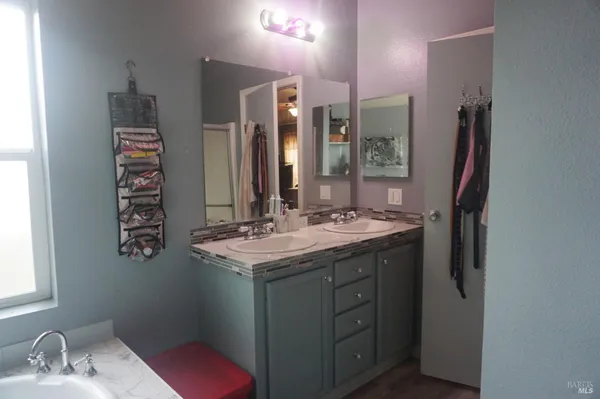 a bathroom with a sink double vanity and a mirror