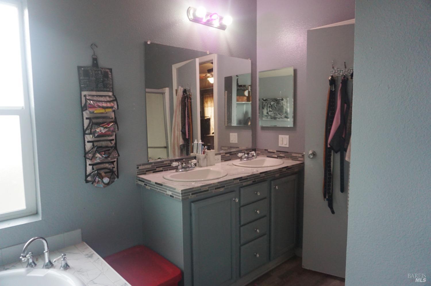 6004 Monticello Road, Unit 7 Napa, CA 94558 - Photo 27 of 33 a bathroom with a sink double vanity and a mirror