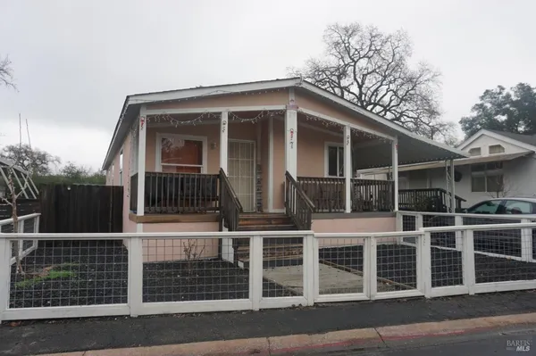 a view of a house with iron fence
