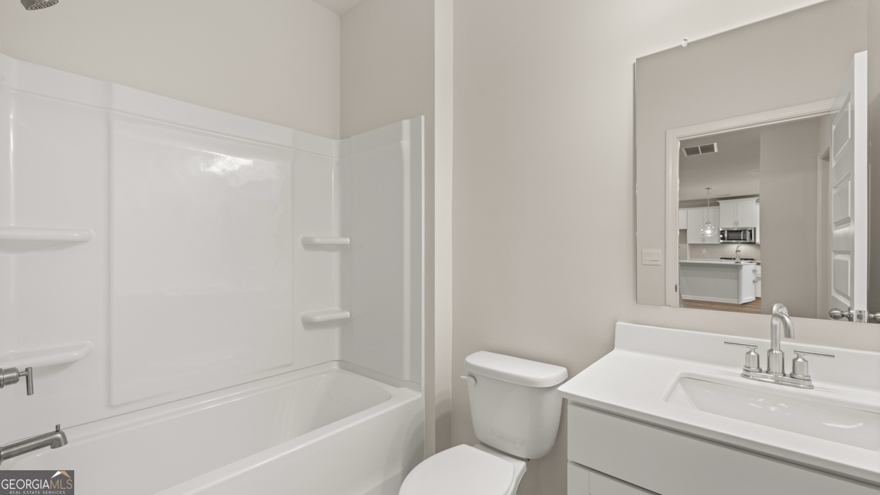 1816 Quaker Street Hampton, GA 30228 - Photo 15 of 32 a bathroom with a sink toilet and shower